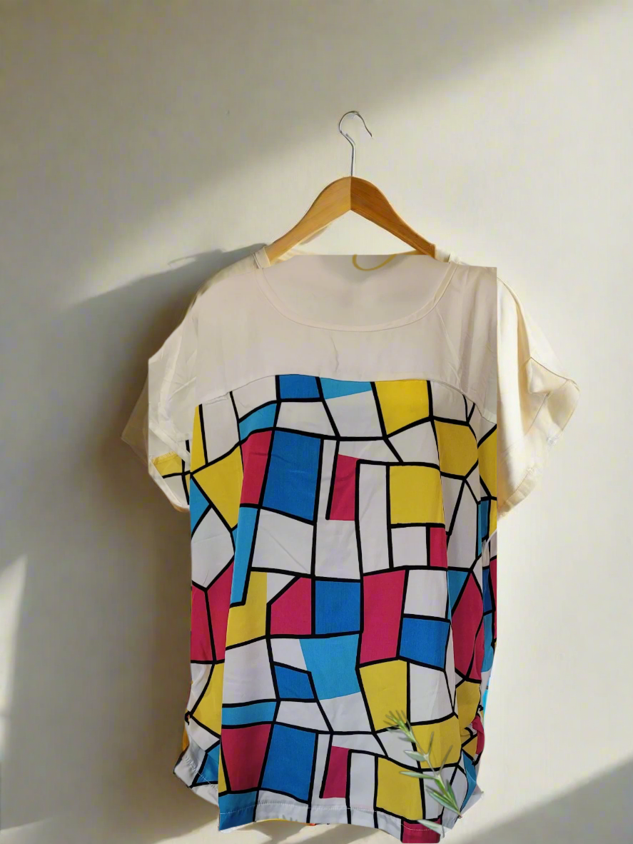 Colorful patterned dress with wedding invitation text 'Join us for the wedding of John & Jane' on a white background.