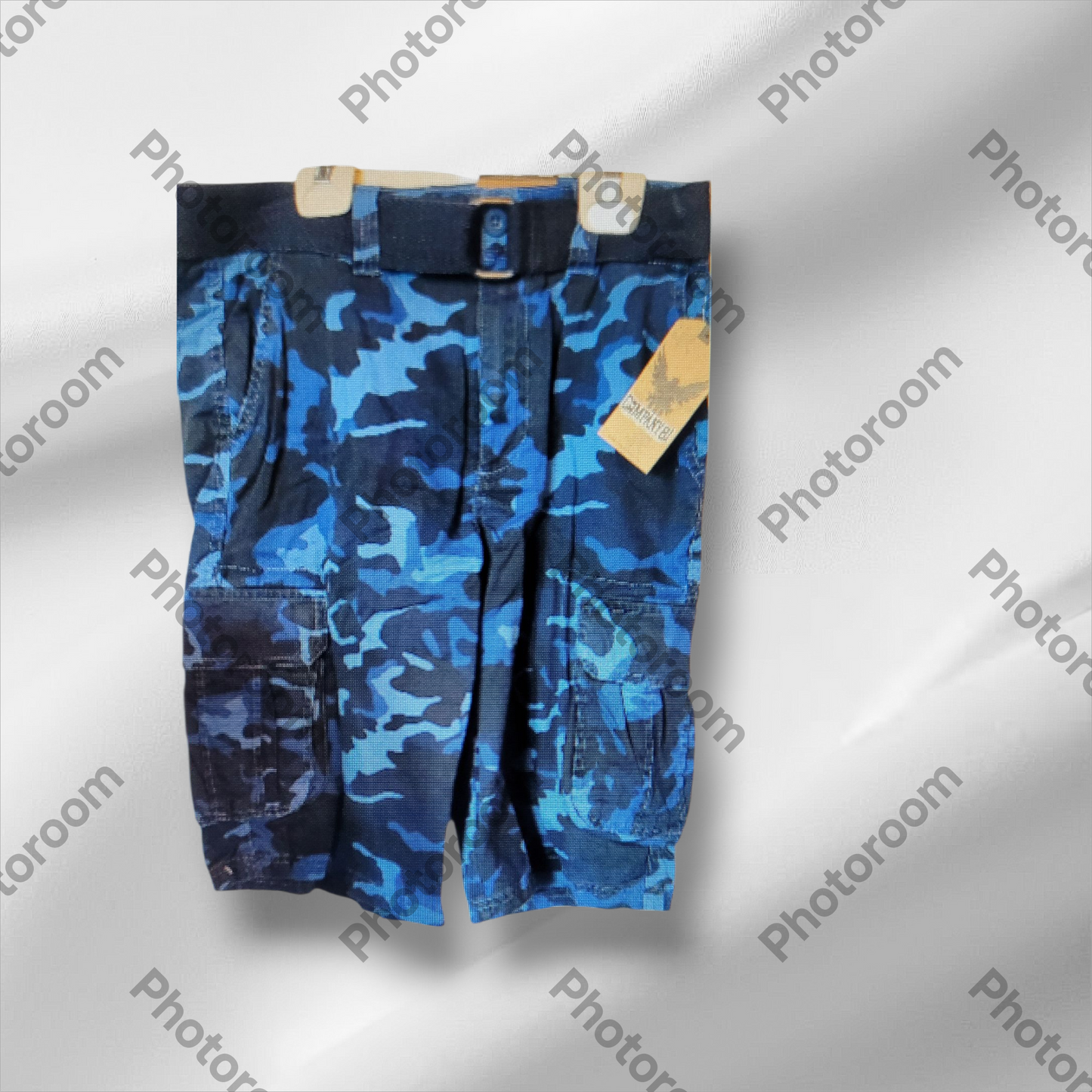 Blue camouflage shorts on a hanger with a visible brand tag against a gray background.