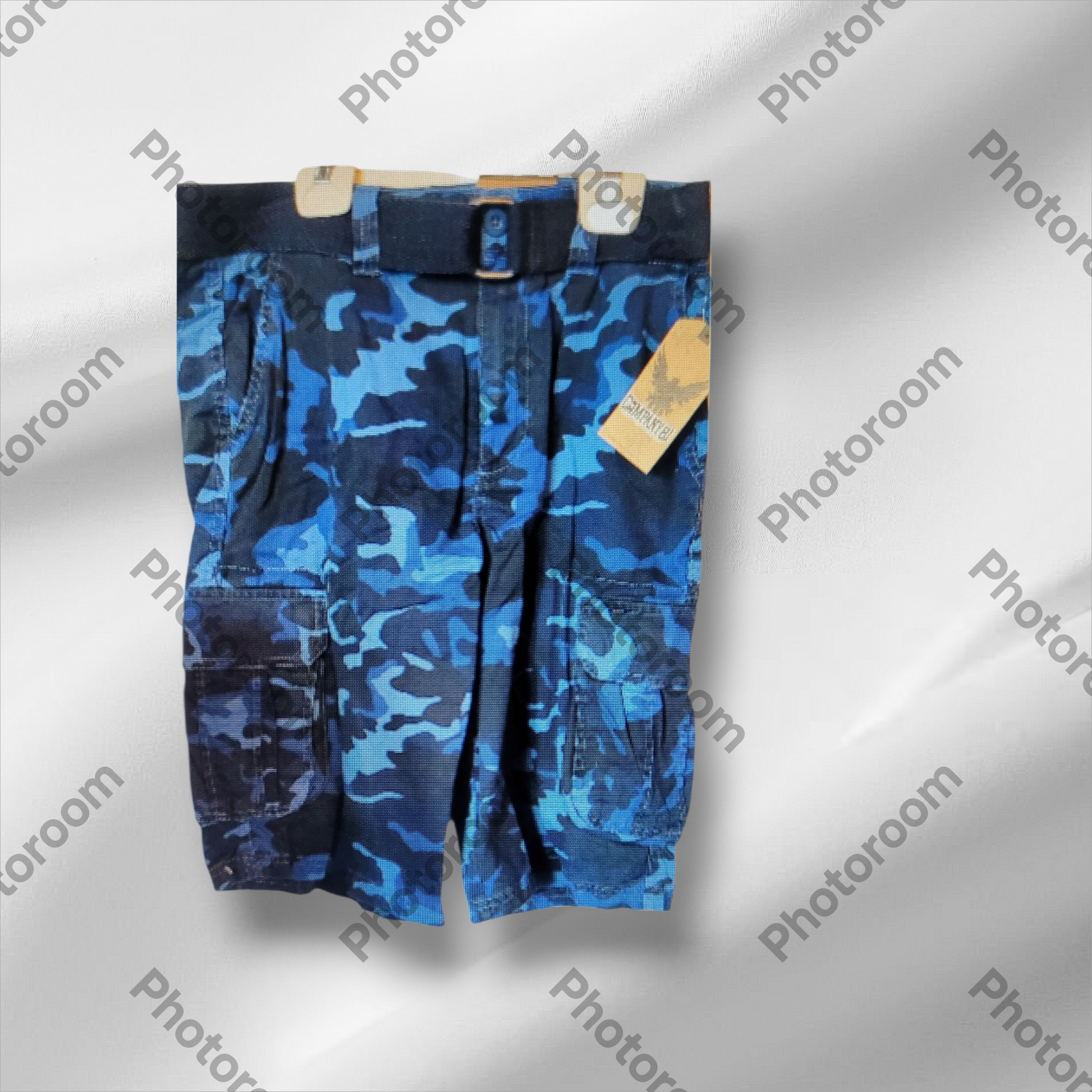 Blue camouflage shorts on a hanger with a visible brand tag against a gray background.