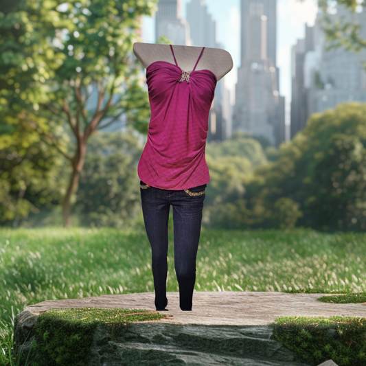 Pink top and jeans in a park with tree and building background