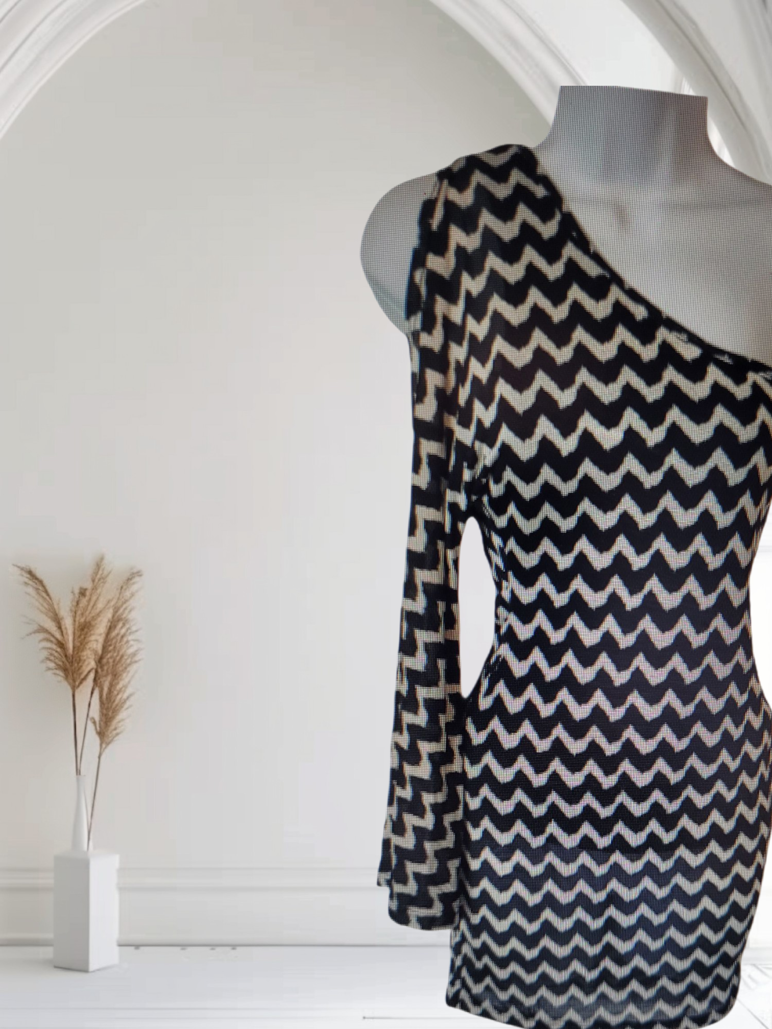 BLACK AND WHITE ZIGZAG PATTERNED FABRIC ON MANNEQUIN TORSO AGAINT AWHITE BACKGROUND