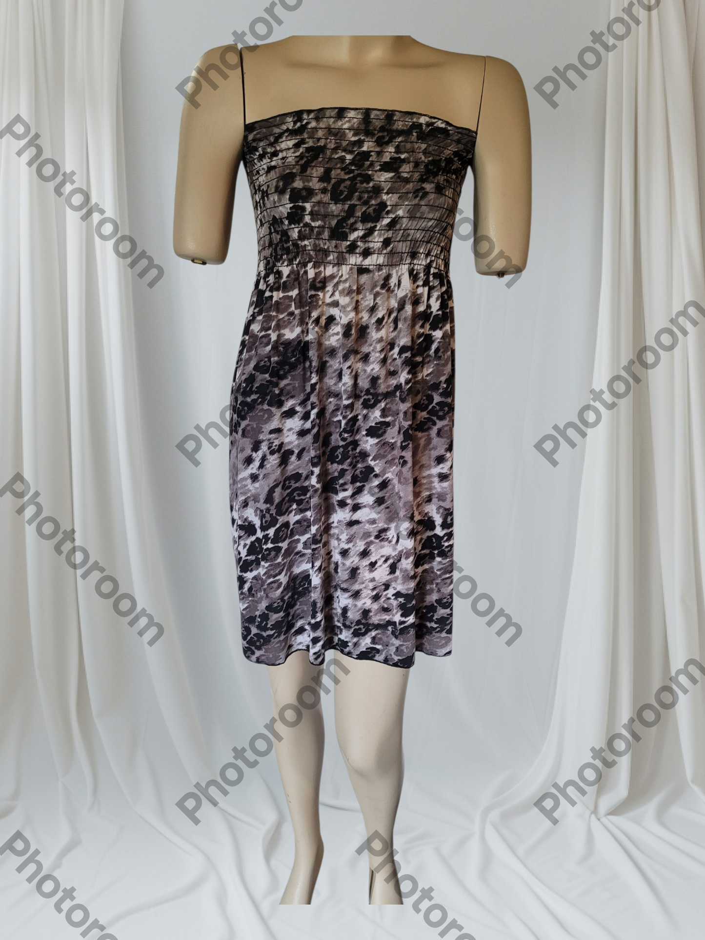 Mannequin wearing a strapless dress with a floral pattern on a white background