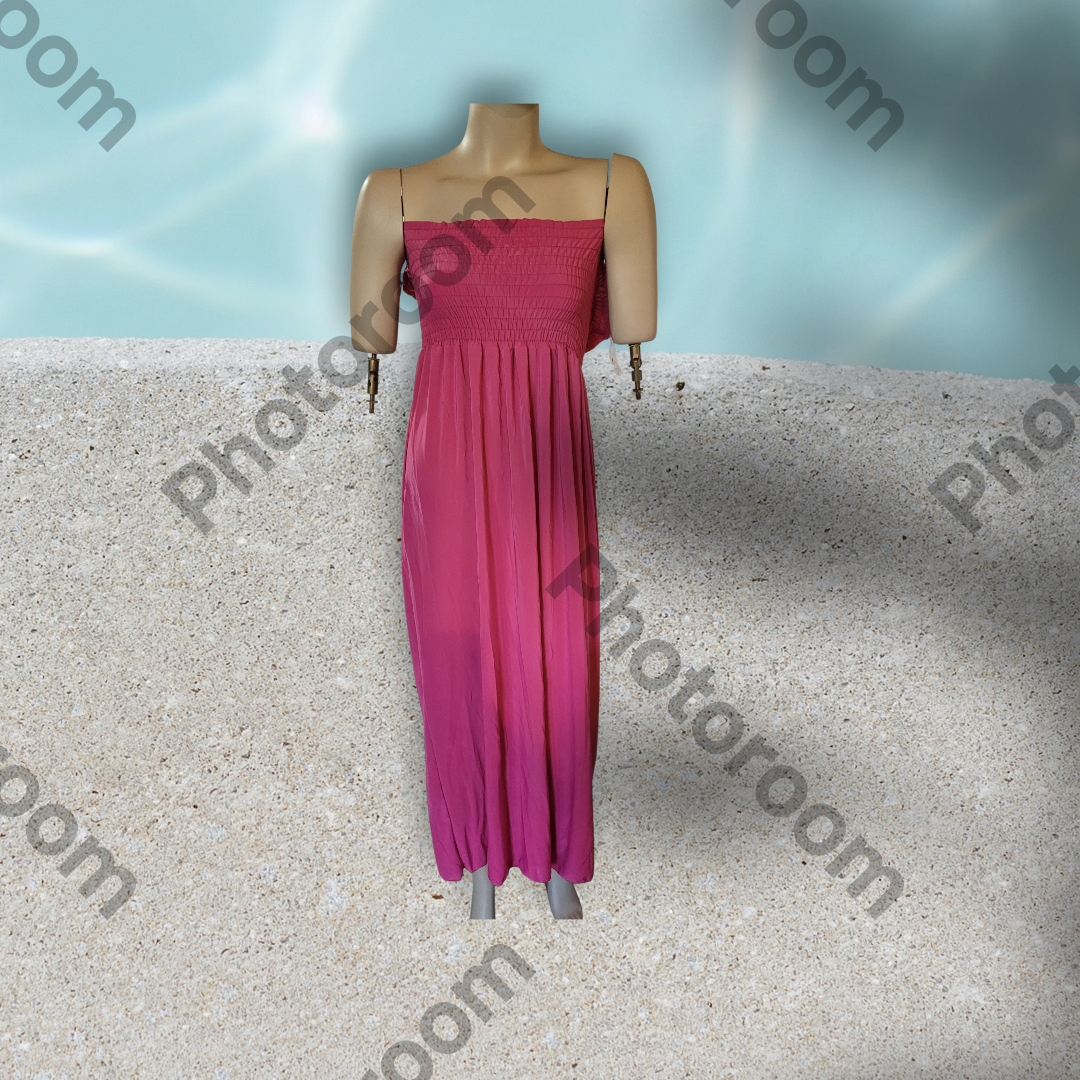 Mannequin wearing a pink dress on a textured surface with 'Photoroom' branding.