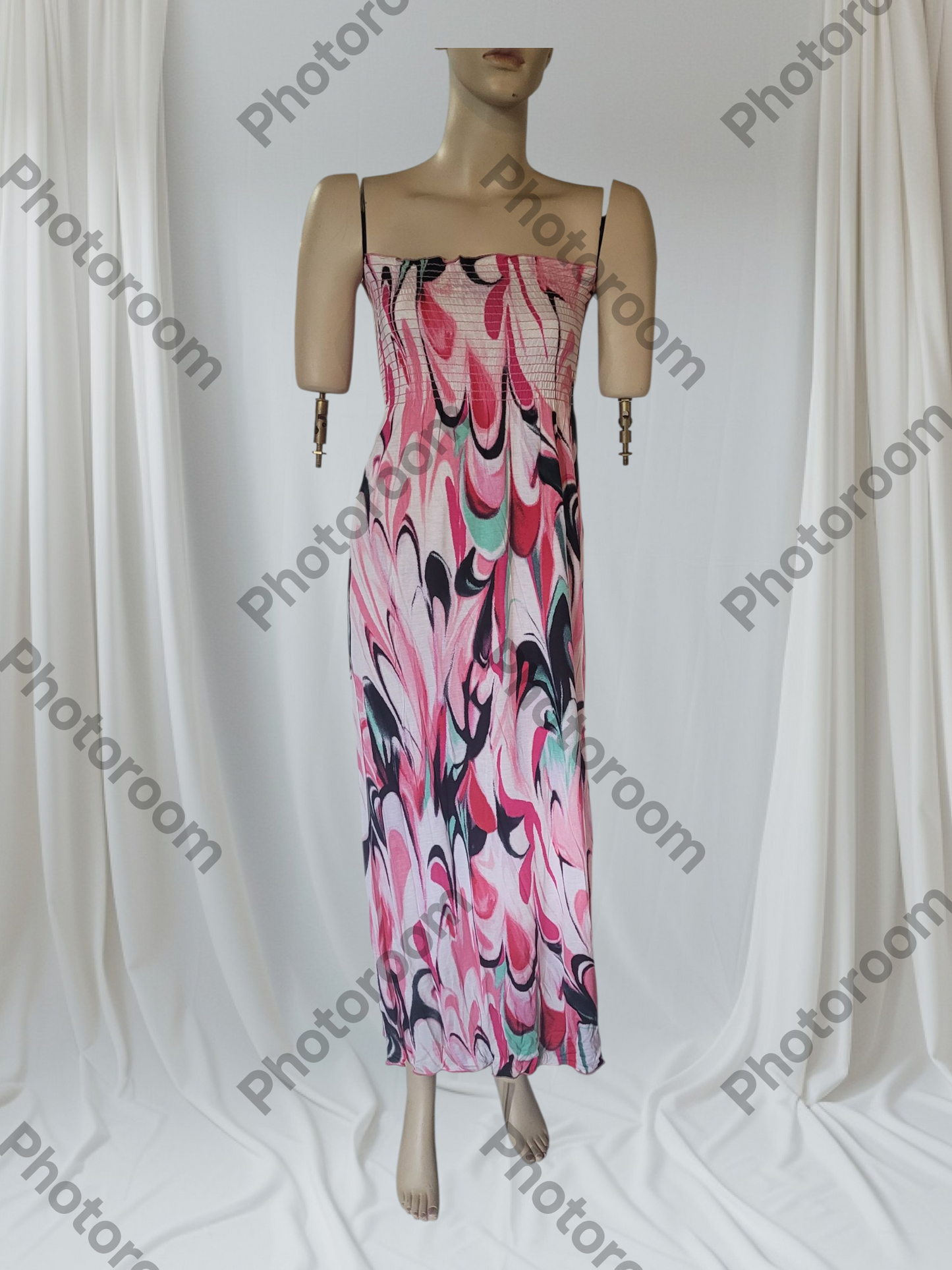 Mannequin wearing a colorful dress with abstract pattern against a white background