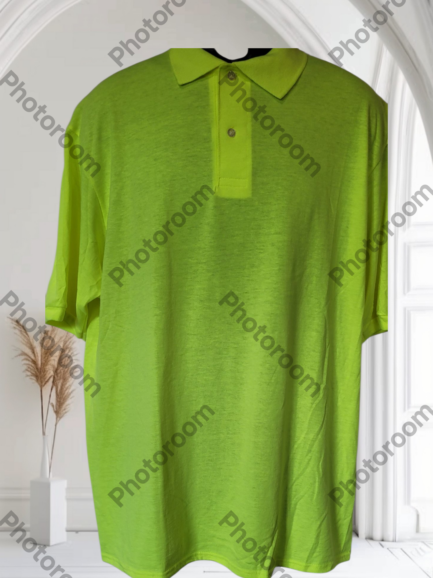 Green polo shirt on a white background with 'Photoroom' branding.