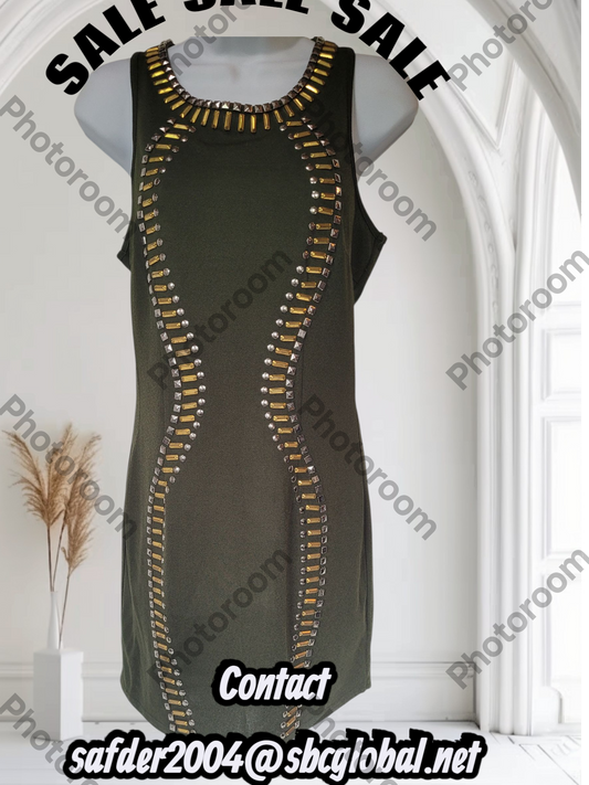 Green dress with gold zipper details on a mannequin against a white background.