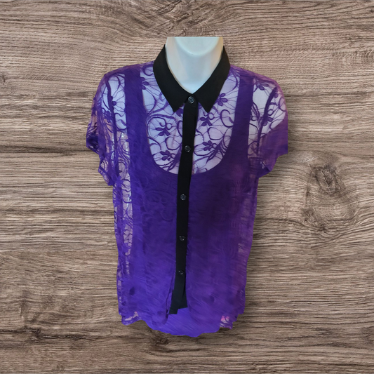 Purple lace blouse with black collar on a mannequin against a wooden background