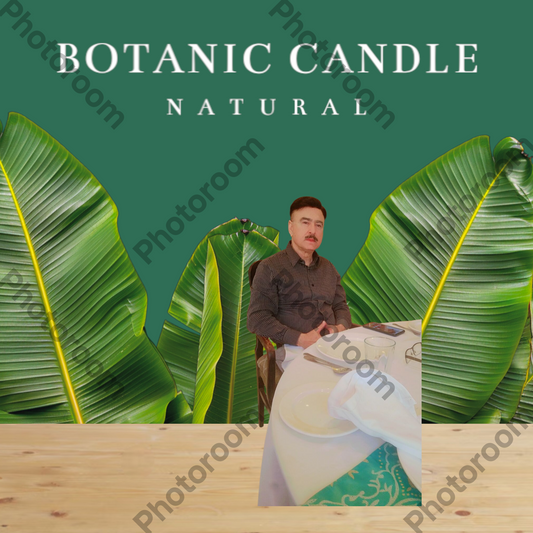 Man sitting at a table with a cup, surrounded by large green leaves with 'Botanic Candle Natural' text.
