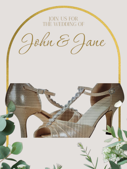Wedding invitation card with gold arch, wedding shoes, and greenery on a light background