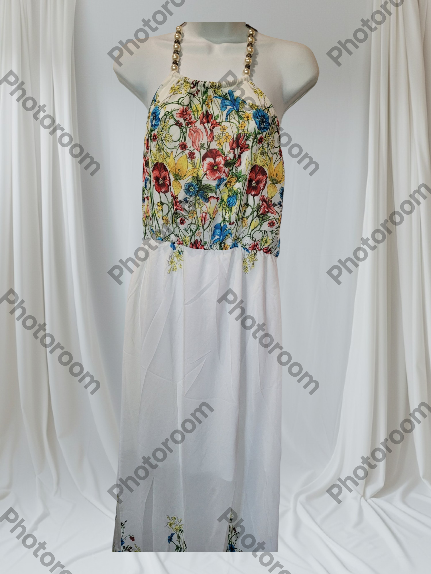Colorful floral dress on a mannequin against a white background with 'Photoroom' watermark.