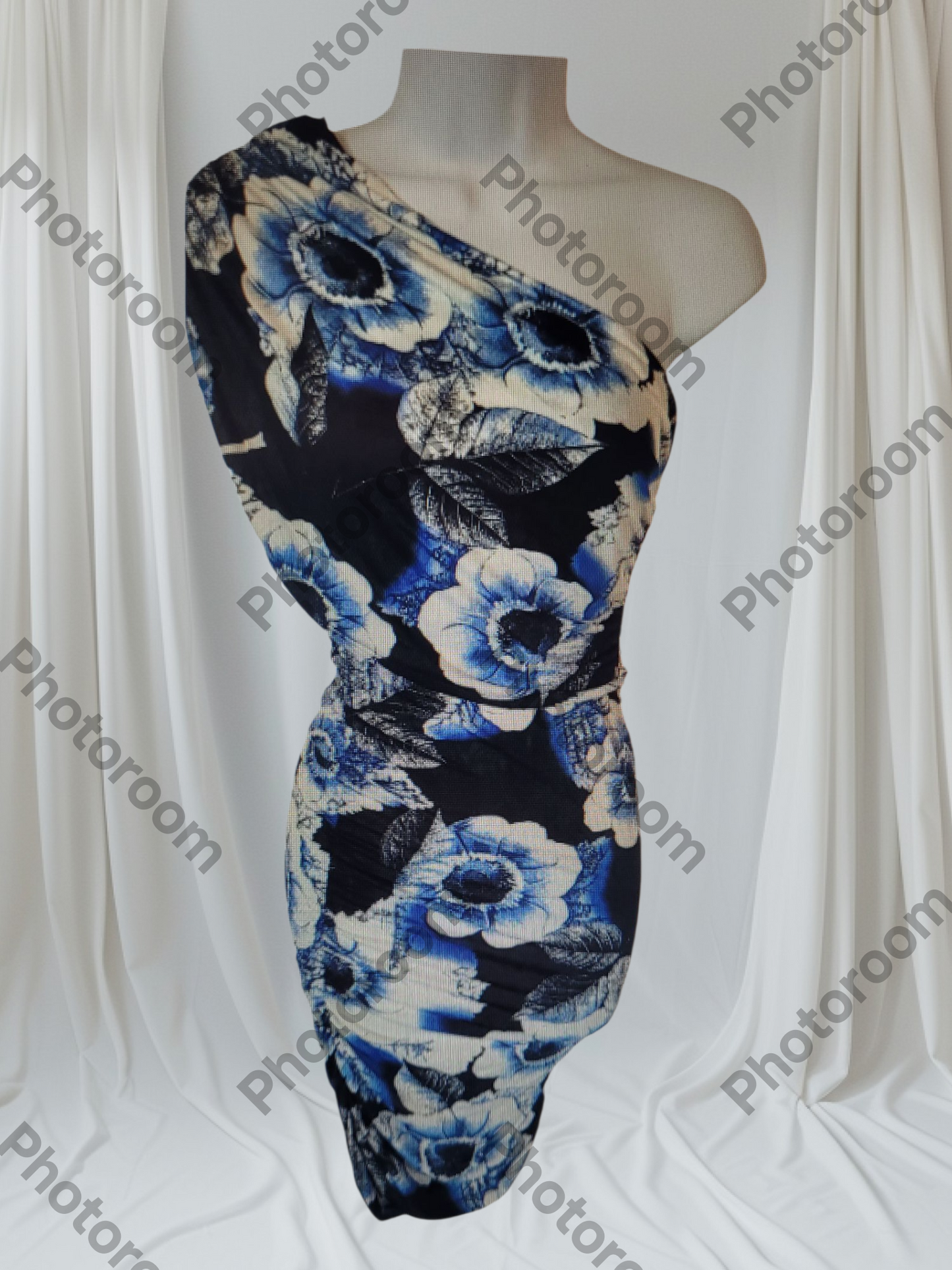 Floral dress on a mannequin against a white curtain background