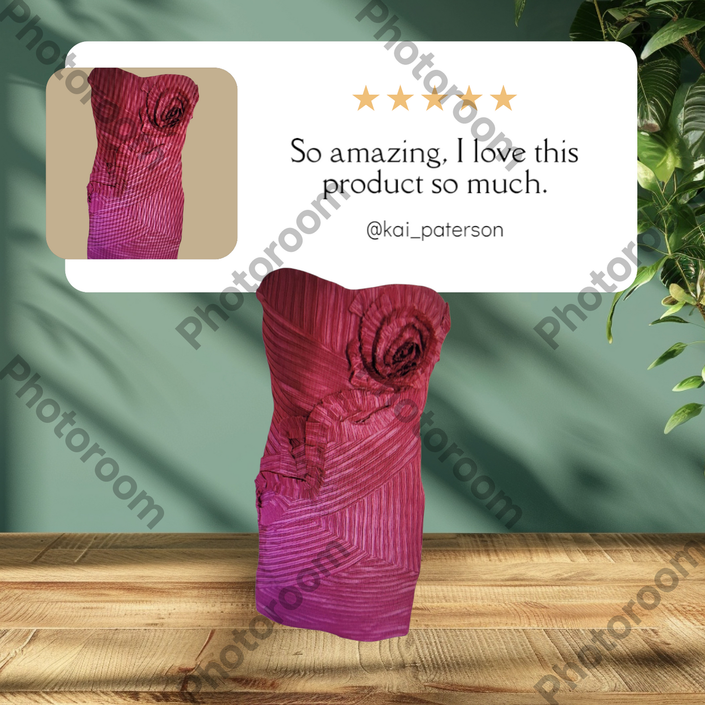 Pink strapless dress with floral detail on a wooden surface, with a green background and 'Photoroom' branding.