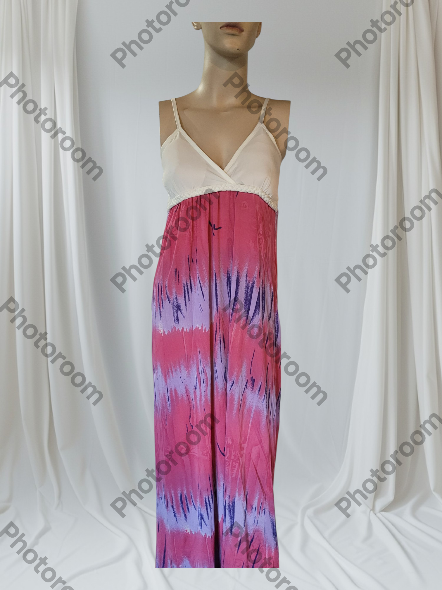 Mannequin wearing a dress with a white top and pink tie-dye skirt against a white curtain background.