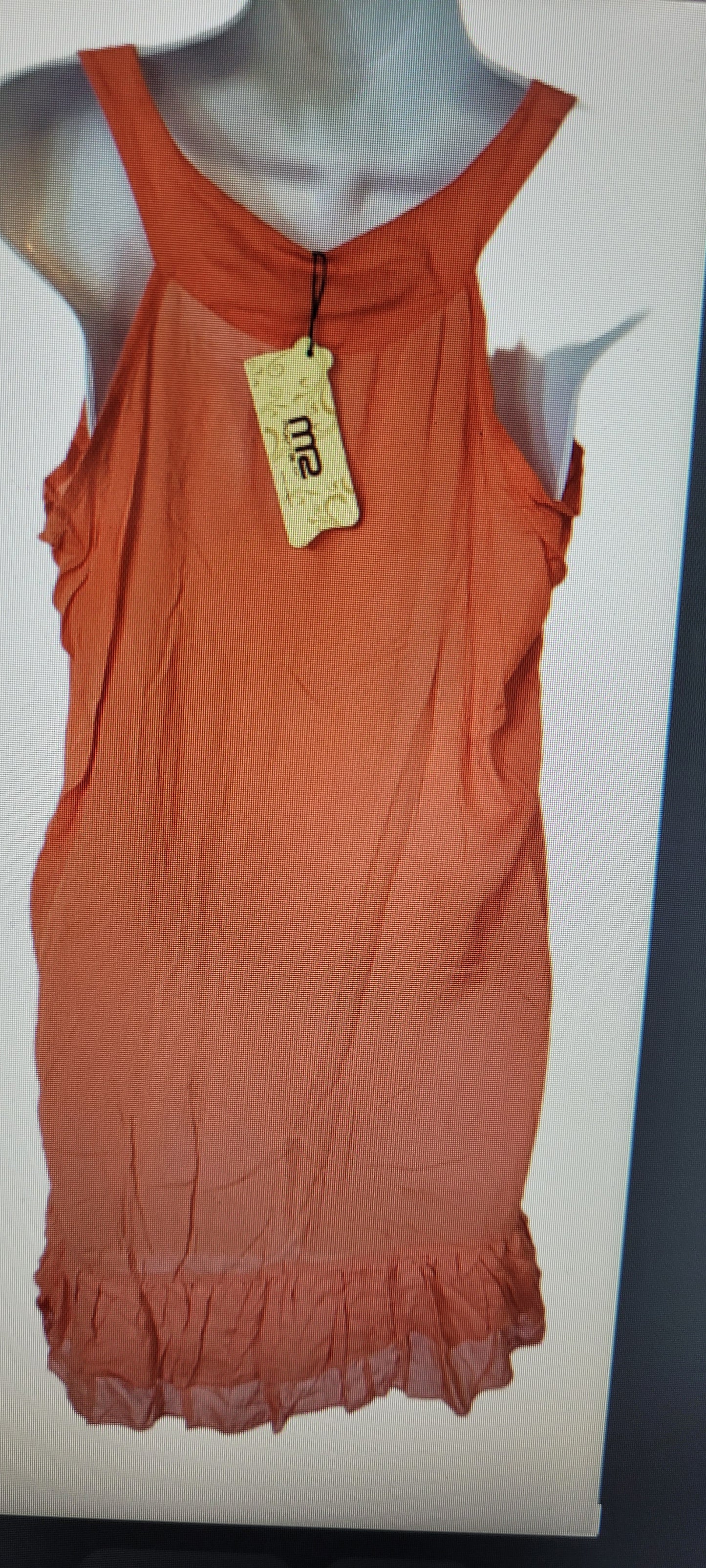 Orange dress on a mannequin with a visible brand tag against a white background