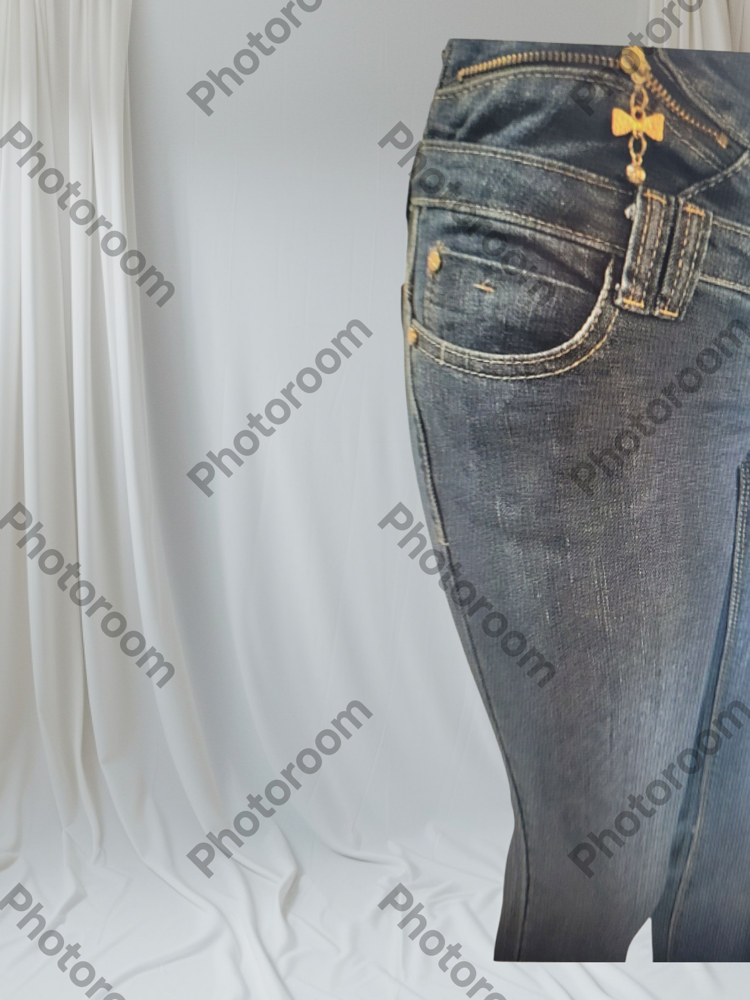 Blue jeans with gold buttons on a white background