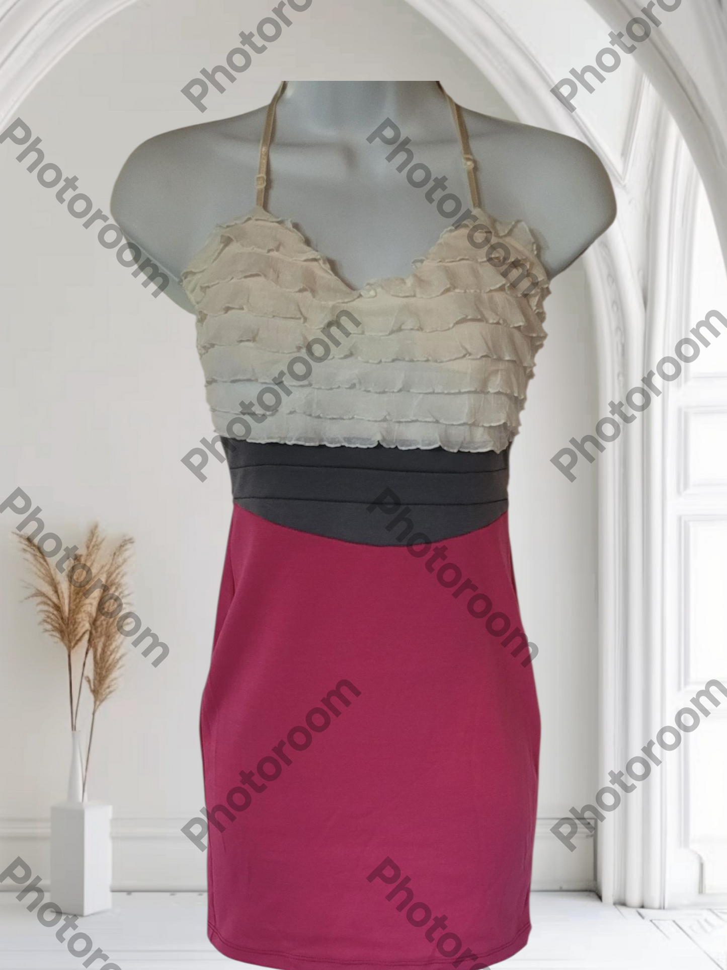 Mannequin wearing a dress with a lace top and solid skirt in a neutral setting.