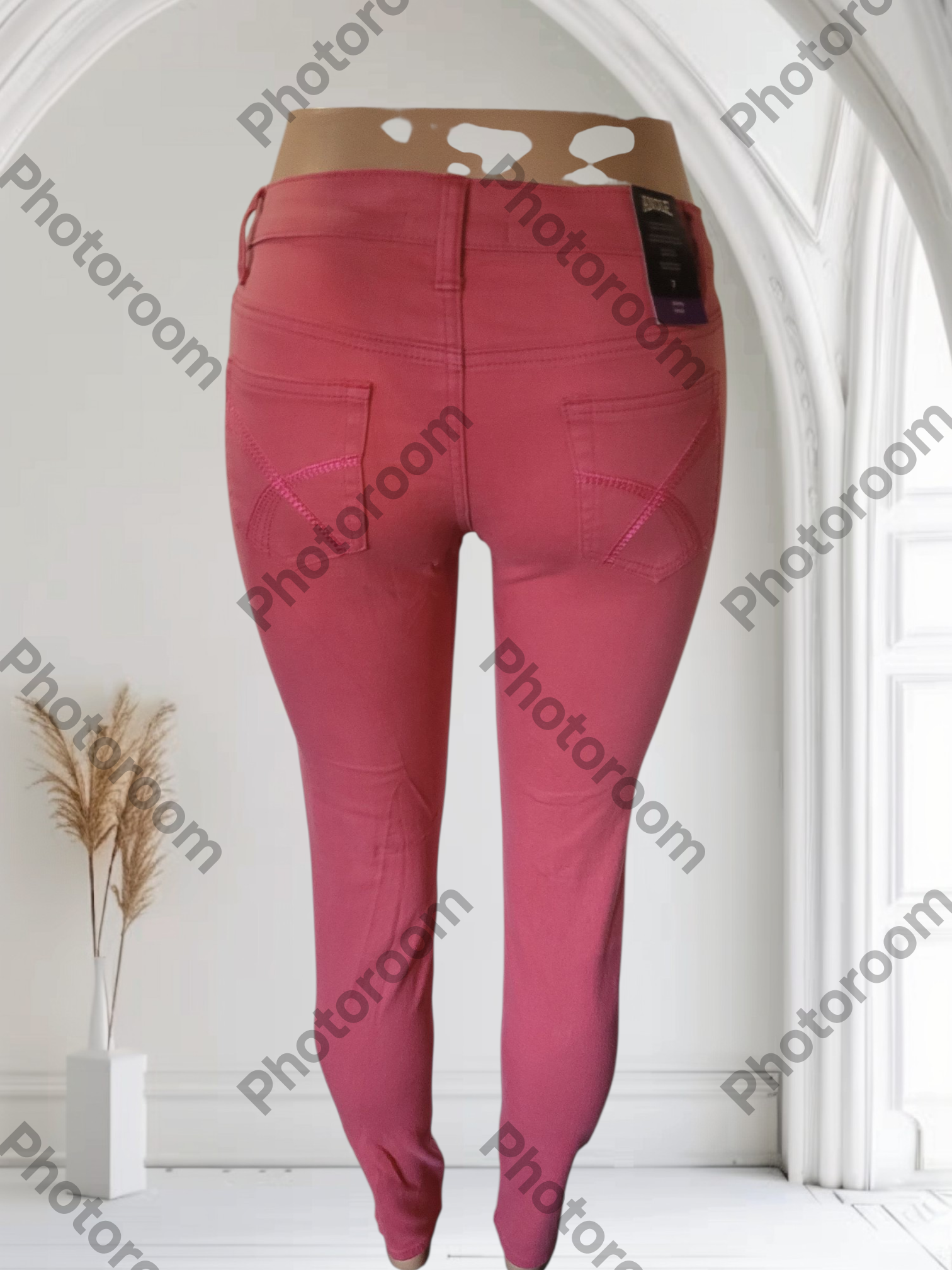 Pink pants displayed against a white background with 'Photoroom' branding.