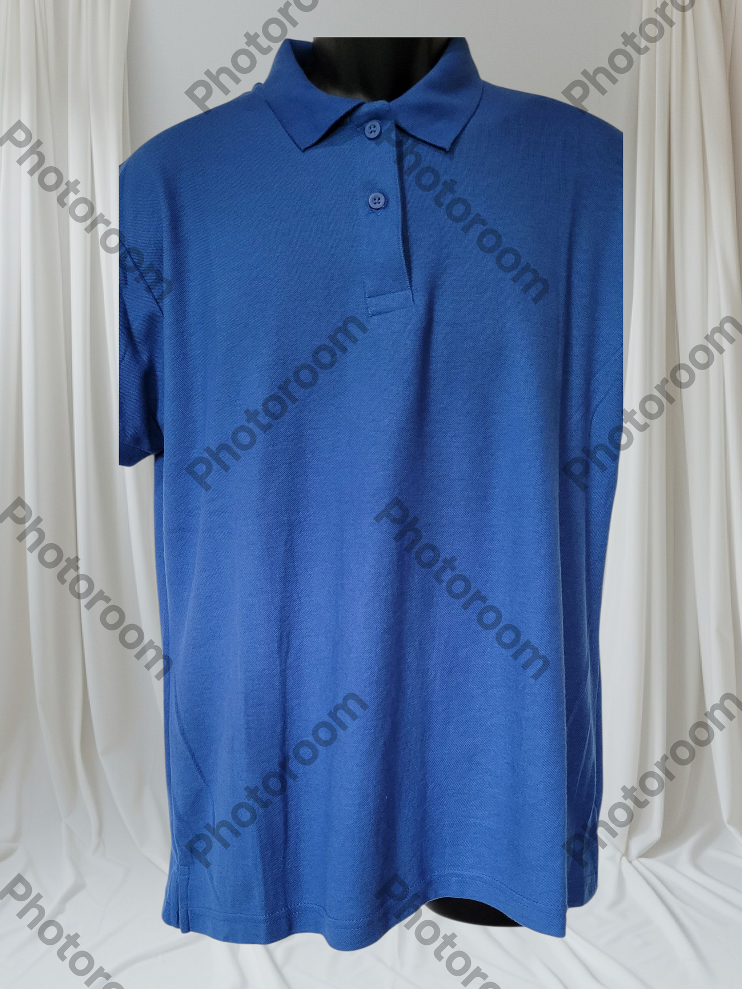 Blue polo shirt on a mannequin against a white curtain background