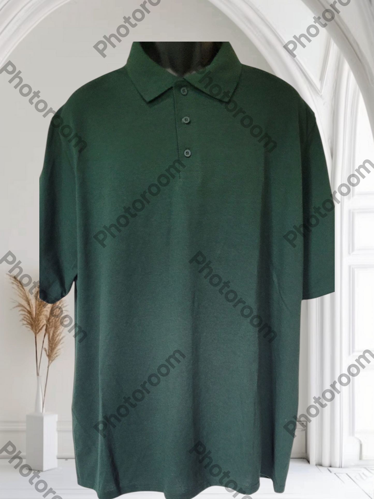 Green polo shirt on a mannequin against a white background with 'Photoroom' watermark.