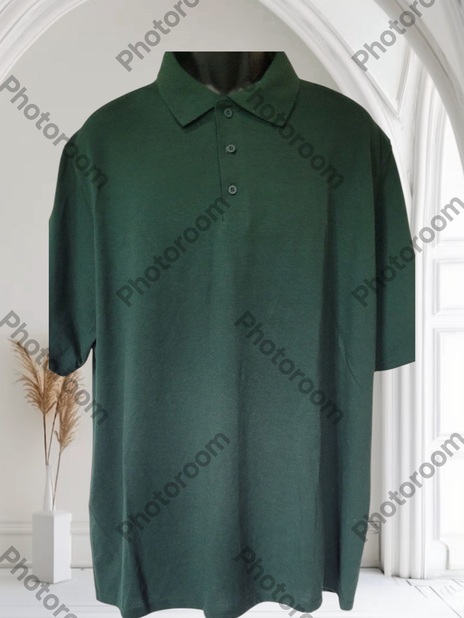 Green polo shirt on a mannequin against a white background with 'Photoroom' watermark.