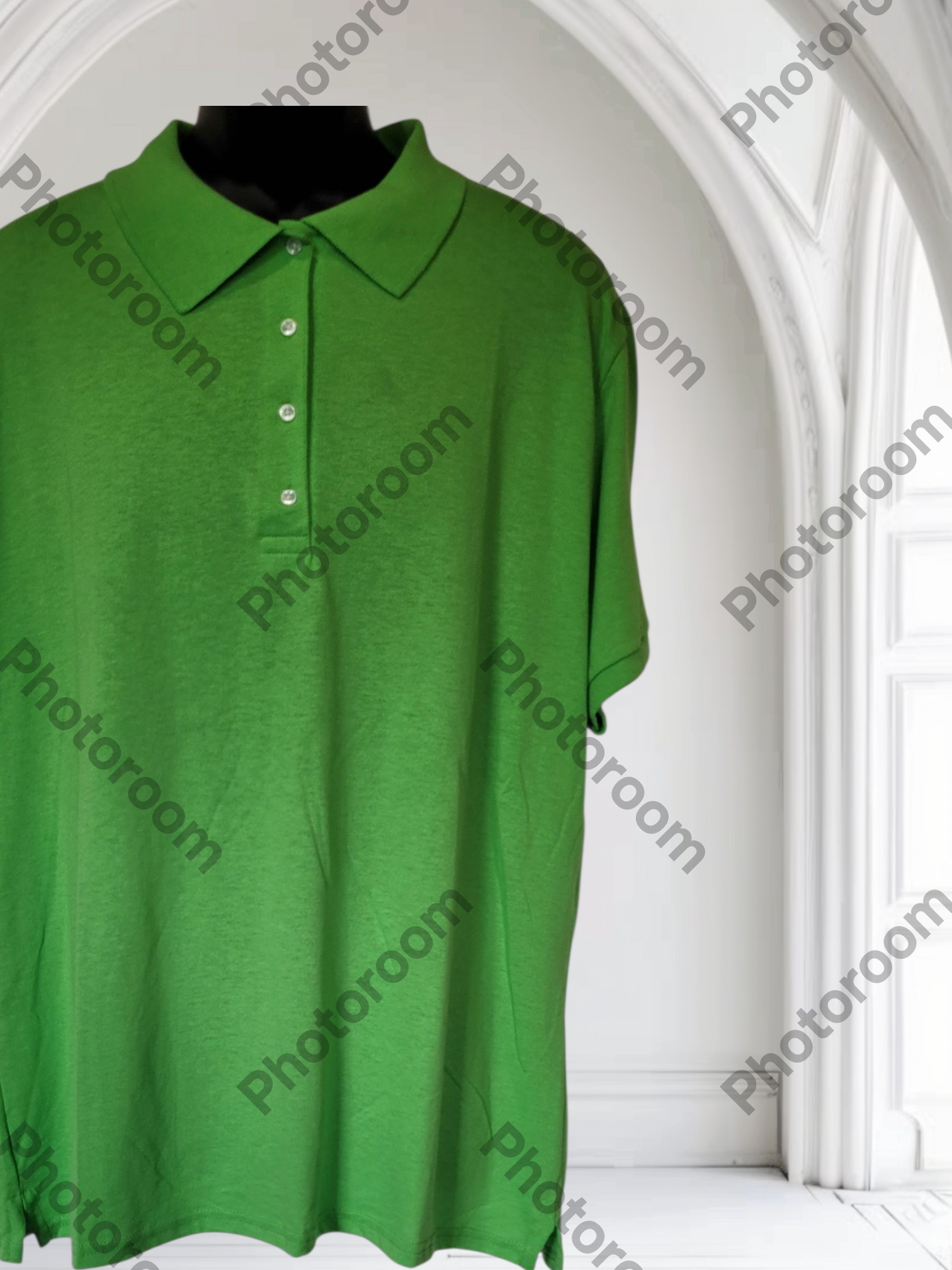 Green polo shirt on a mannequin against a white background with 'Photoroom' watermark.