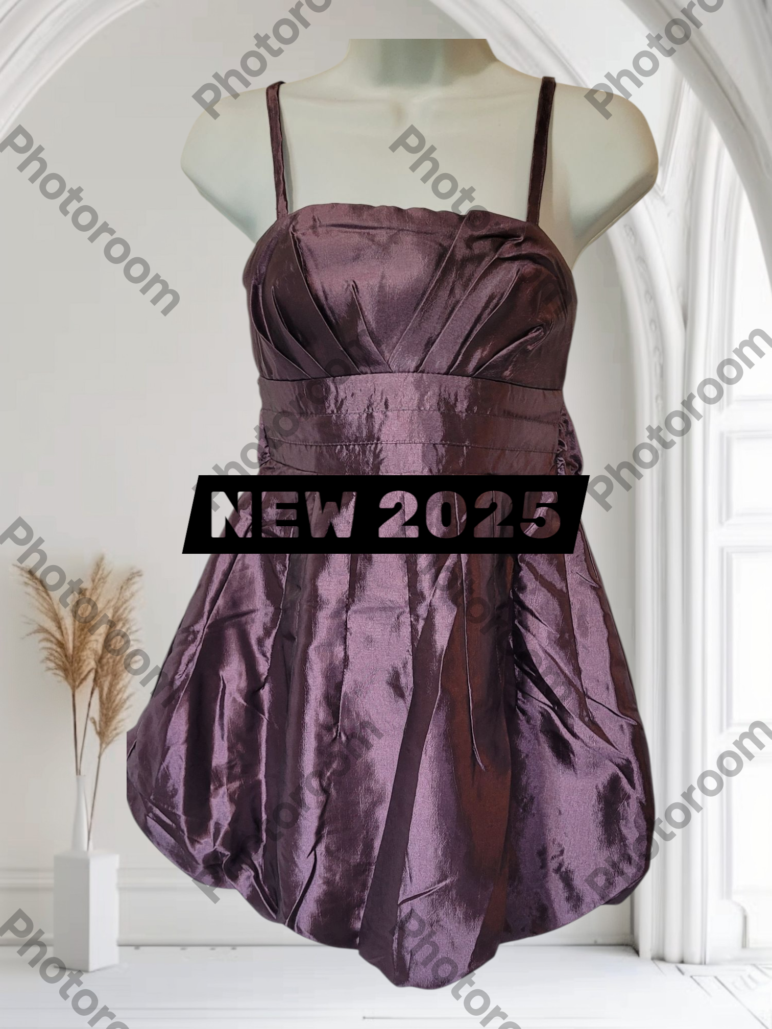 Purple dress on a mannequin with 'NEW 2025' label in a white room.