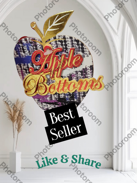 Decorative sign with 'Apple Bottoms' logo and 'Best Seller' text in a room setting.