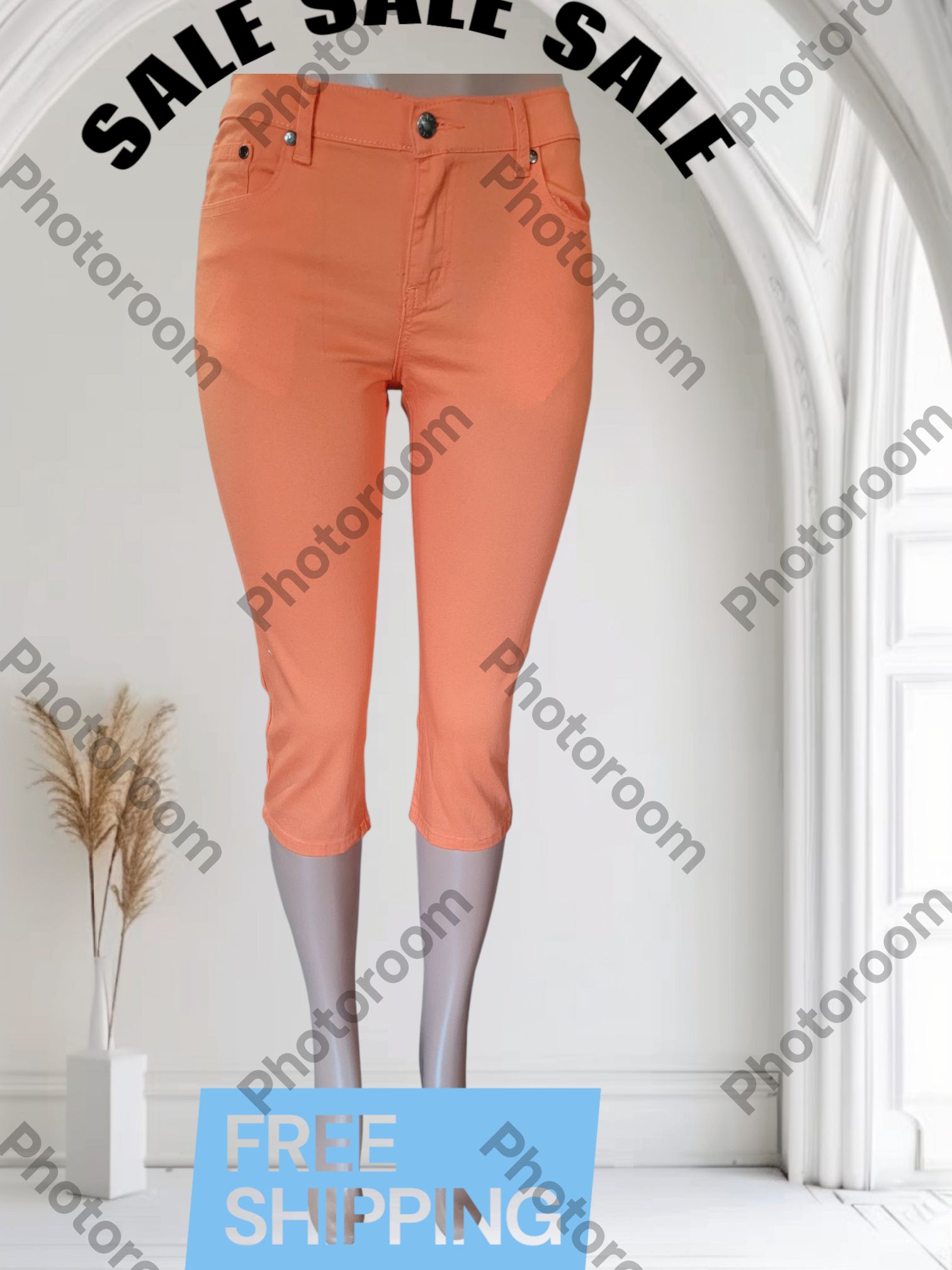 Orange pants on a mannequin in a room with 'Photoroom' watermark