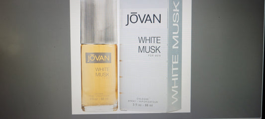 Jovan White Musk perfume bottle and packaging on a gray background