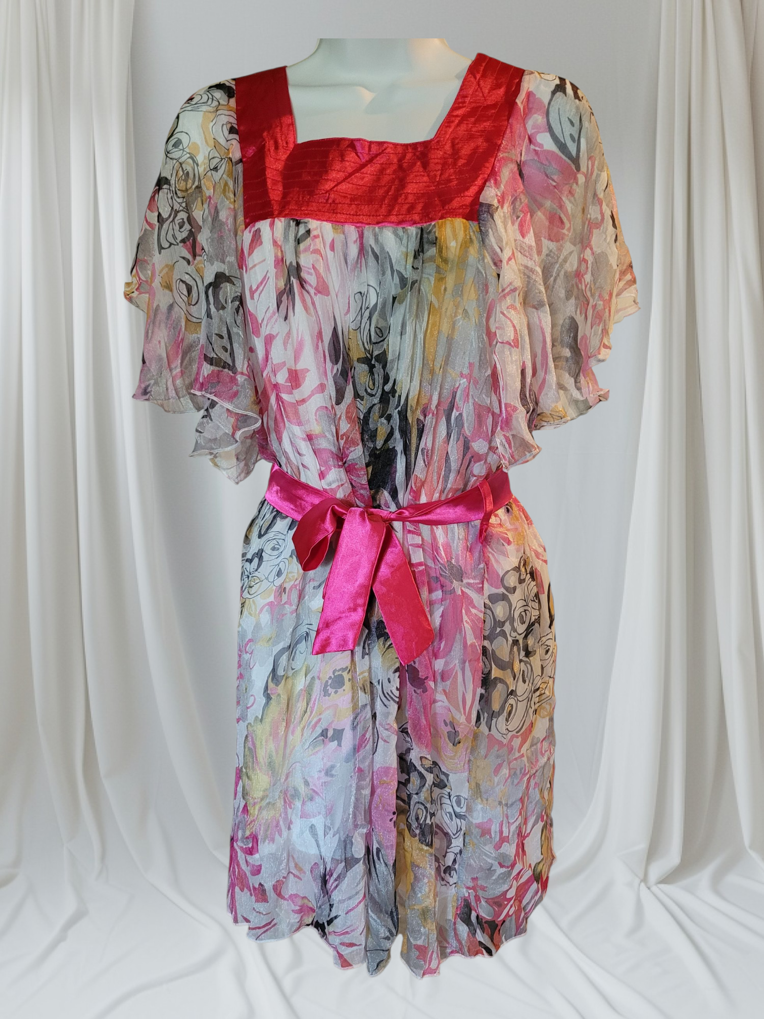 Colorful dress with a red bodice and pink belt on a white background